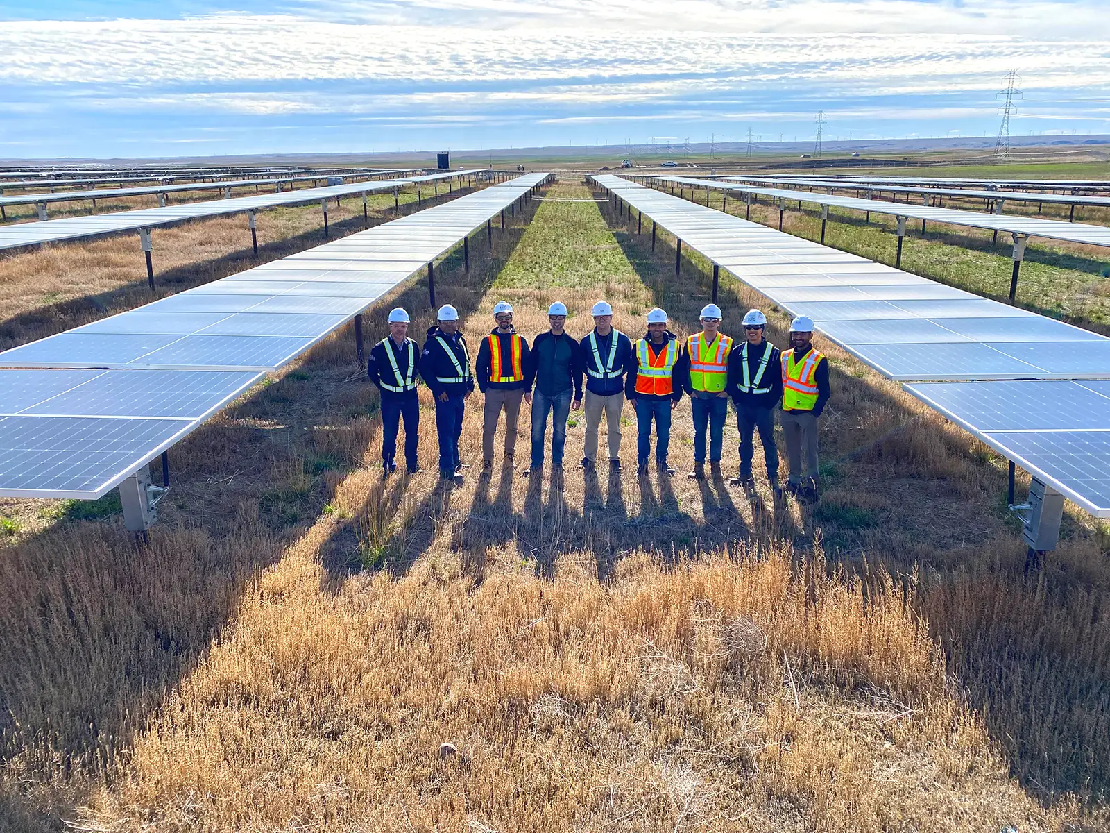 Kilo Power Calgary men with safety gear on field with solar panels